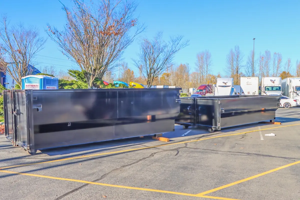 Professional dumpster rental service with roll-off container on residential driveway in Southport